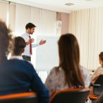 Facilitator on training of trainers explains project cycle management Facilitator on training of trainers explains project cycle management